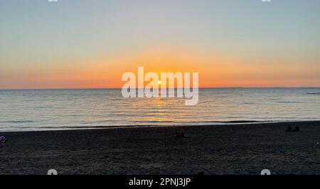 Sunset over the Irish Sea from seaside resort in West Wales. Stock Photo