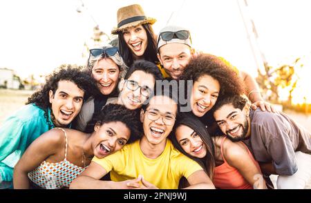 Multi racial diverse friends taking selfie at beach party festival - Happy life style and summer holidays concept on trendy generation people Stock Photo