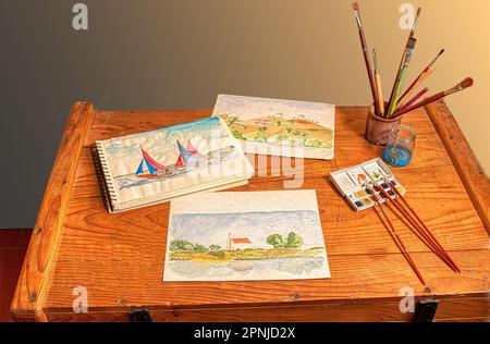 Watercolor painting, a light and immediate way to record your travel impressions. Some artwork and tools on a rustic wooden chest of drawers. Stock Photo