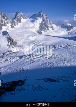 The twin peaks of L'Eveque peaks rise above the Otemma glacier as seen from the Swiss Alpine Club hut Cabane Vignettes on the Chamonix to Zermatt Haute Route Stock Photo