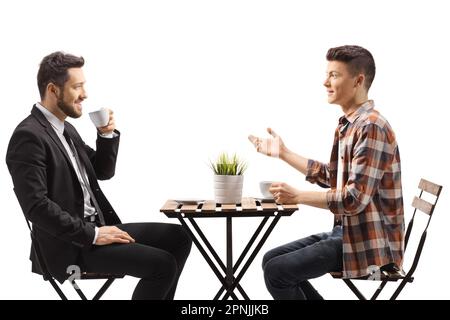 Businessman and a teenge guy sitting at a coffee table isolated on white background Stock Photo
