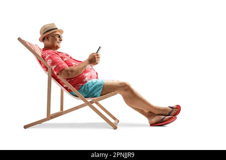 Mature male tourist sitting on a beach chair with a smartphone isolated on white background Stock Photo