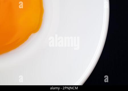 Egg yolk on the plate. Abstract fried eggs. Close up. Stock Photo