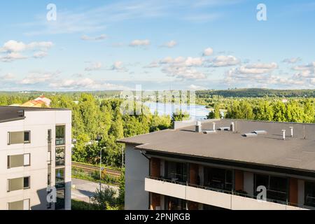 Building with apartments, condos in residential area. Park, green forest and lake landscape view. Outside facade of house. Rental housing.