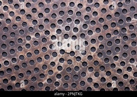 perforated metal bottom with small circular holes, top view Stock Photo