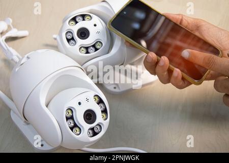 White IP camera, technician setting up camera operation Stock Photo