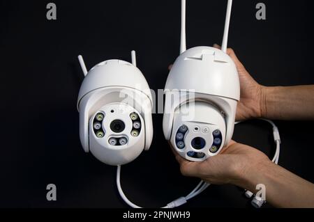 Two white IP cameras placed on a black background Stock Photo