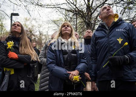 Warsaw, Poland, 19/04/2023, Citizens and participants of the ceremony are seen holding daffodils as a symbol of the Ghetto Uprising during the ceremony. Poland marked the 80th anniversary of the Warsaw Ghetto Uprising - a violent revolt that occurred from April 19 to May 16, 1943, during World War II. Residents of the Jewish ghetto in Nazi-occupied Warsaw, staged the armed revolt to prevent deportations to Nazi-run extermination camps. The Uprising became an everlasting symbol of the resistance of Polish Jews against the Holocaust. Between 1942 to 1943 Germans transported over 300,000 Jews fro Stock Photo