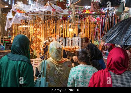 April 19, 2023, Srinagar, Jammu and Kashmir, India: Kashmiri women seen shopping at a jewelry shop ahead of the Muslim festival Eid-al-Fitr at a local market in Srinagar. Markets across the Muslim world witness huge shopping rush in preparation for Eid al-Fitr, a celebration that marks the end of the Muslim fasting month of Ramadan. (Credit Image: © Faisal Bashir/SOPA Images via ZUMA Press Wire) EDITORIAL USAGE ONLY! Not for Commercial USAGE! Stock Photo
