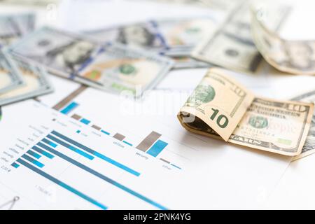 business graph chart paper pen calculator us dollar on office desk. Checking financial reports. Stock Photo