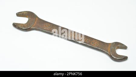Vintage rusty Iron Spanner Double Sided Open End Wrench with price engraved on white background Stock Photo