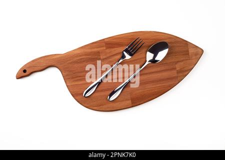 Title	 Spoon and fork on the cutting board. Top view. Stock Photo
