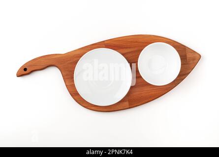 An empty white bowl on a cutting board. Blank bowl. Top view. Stock Photo