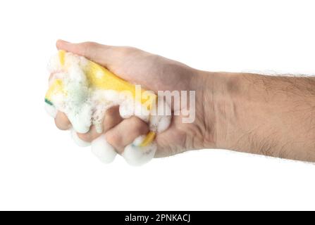 Sponge for washing and cleaning in male hand. Hand isolated on white. A hand holds a sponge for washing and cleaning. Stock Photo