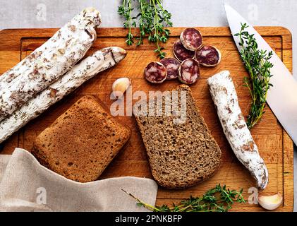 Spanish fuet sausage sliced ​​on a board Stock Photo