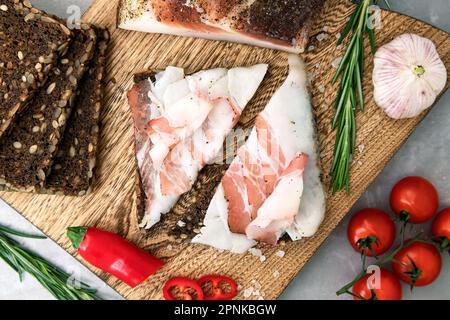 Delicious lard on a cutting board with vegetables Stock Photo