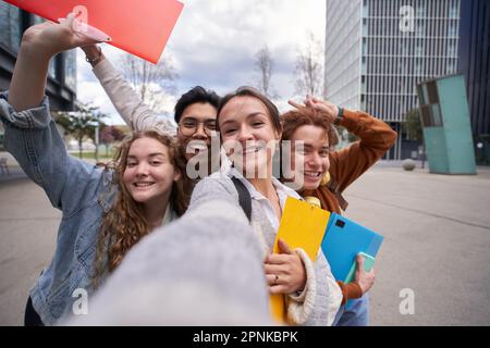 Smiling multiracial college students taking a selfie back to school. Happy friends photo together Stock Photo