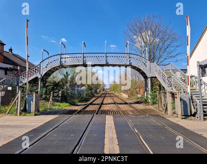 Old wrought iron footbridge over a railway crossing in Long Eaton, Derbyshire, UK Stock Photo