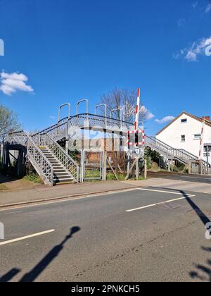 Old wrought iron footbridge over a railway crossing in Long Eaton, Derbyshire, UK Stock Photo