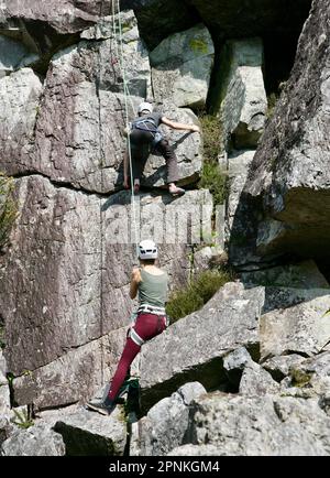 Two brave rock climbers at Fosse Arthour, Saint Georges De Rouelley, Normandy, France, Europe Stock Photo