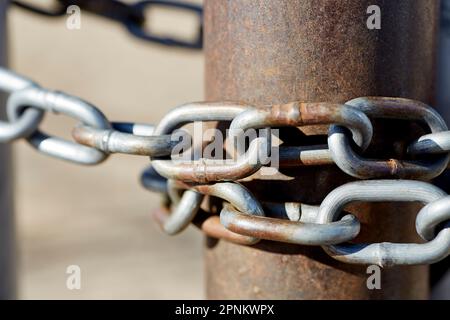 Close up of a Steel Gate Chain around a Rusted Pipe Stock Photo