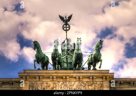 Berlin, Germany - April 30, 2014: The bronze sculpture Quadriga on top of the Brandenburg Gate in Berlin City, Germany. Stock Photo