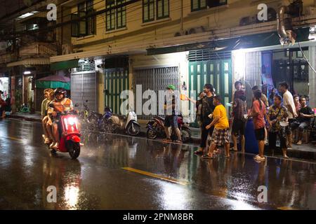 Bangkok, Thailand - April 15, 2023: A group of unidentified people enjoying Songkran on the streets of Bangkok, Thailand. Stock Photo