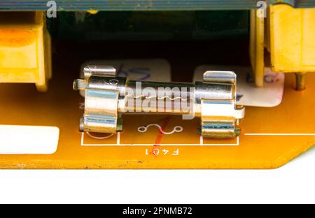 Glass tube fuse on electronics circuit board of electrical appliances, Electronics part concept. Stock Photo