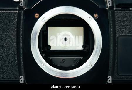 Close up of mirror shutter on SLR single lens reflex or film camera for image recorder. Stock Photo