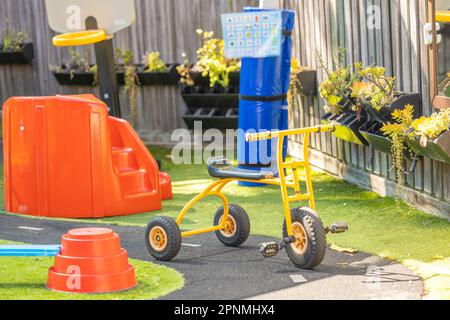 Cute yellow trike in kindergarten yard with no people Stock Photo