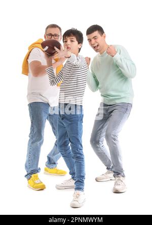 Happy little boy with his dad and grandfather playing rugby on white background Stock Photo