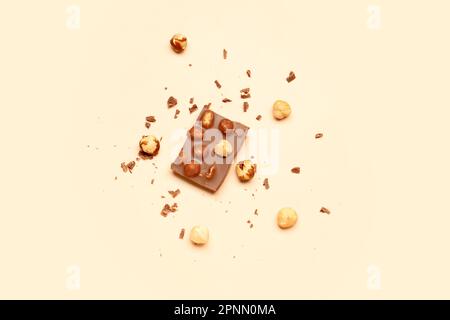 Sweet tasty chocolate with nuts on  beige background Stock Photo