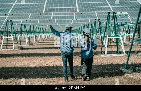 Solar design engineers visually inspect photovoltaic array installation ...