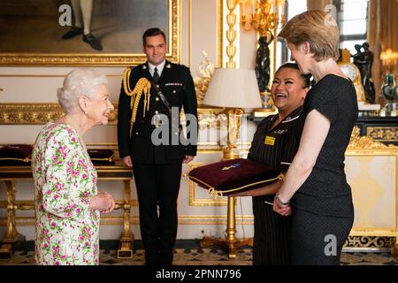 File photo dated 12/7/2022 of Queen Elizabeth II, presenting the George Cross to Ms Amanda Pritchard, Chief Executive of NHS England, and Ms May Parsons, Modern Matron at University Hospital Coventry and Warkwickshire, representatives of the National Health Service during an Audience at Windsor Castle, Berkshire. NHS workers who helped the service to be awarded the prestigious George Cross will be able to get a glimpse of the medal as it 'tours' the nation. The award was bestowed upon the NHS for the work staff performed during the Covid-19 pandemic and during its history. Issue date: Thursday Stock Photo