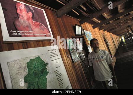 Bandi, popularly known as Apay Janggut, an environmental defender and elder of the traditional community of Dayak Iban community, gives explanation as he is standing in front of the map of the customary forest his community is managing, at their longhouse in Sungai Utik, Kapuas Hulu, West Kalimantan, Indonesia. Indigenous knowledge can be a unique source for techniques for climate change adaptation and may be favoured over externally generated knowledge, according to the 2023 report published by the Intergovernmental Panel on Climate Change (IPCC). Stock Photo