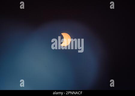 Solar Eclipse on April 20, 2023, showing the moon partially covering the sun. This was observed as a total eclipse in other places. Stock Photo