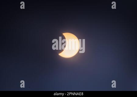 Solar Eclipse on April 20, 2023, showing the moon partially covering the sun. This was observed as a total eclipse in other places. Stock Photo