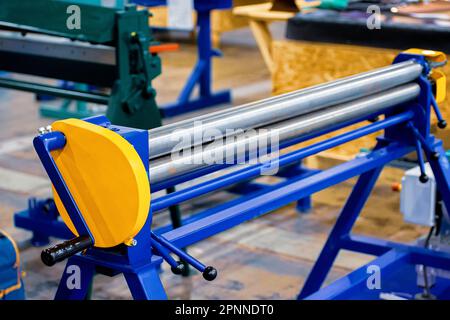 Manual roller bending machine. Metal sheet bending machine. Stock Photo