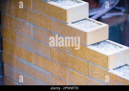 Fragment of corner brickwork. Insulated bricks. Stock Photo