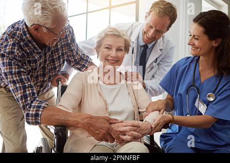 Theyve been great. a senior couple in the retirement with their doctor and nurse. Stock Photo