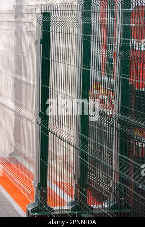 Green steel bar fence. Modern fencing systems. Stock Photo