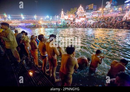 Naked Naga-Sadhus taking a holy bath during the Kumbha or Kumbh Mela in