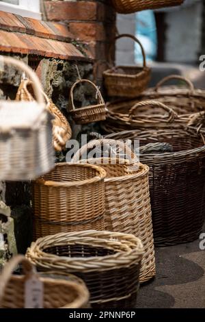 A pile of handmade traditional woven baskets made from straw, natural fiber, for sale at the outdoor marke Stock Photo