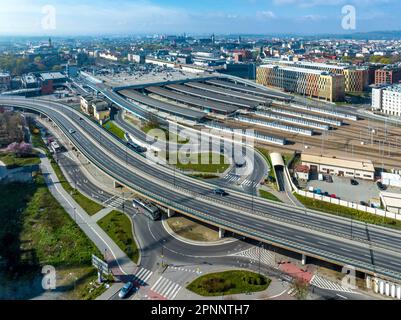 Krakow, Poland. Cityscape with Main railroad station with big parking lot on its roof. Elevated city highway with junctions, rotary and ramps. Old tow Stock Photo