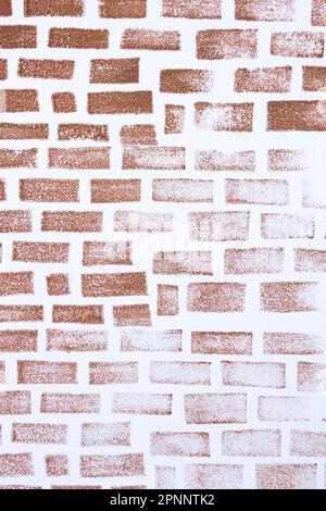 simulation of a brick wall made with a handmade stamp and stamped with brown color on white cardboard. vertical. Stock Photo