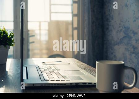 Home workspace with computer in apartment. Freelancer or student workplace at home for remote education or distance working. Toned shot Stock Photo