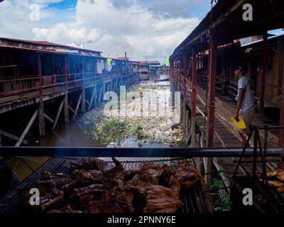 Iquitos, Peru - Apr, 2022:  Floating shantytown of Belén, consisting of scores of huts, built on rafts, which rise and fall with the river. Latin Amer Stock Photo