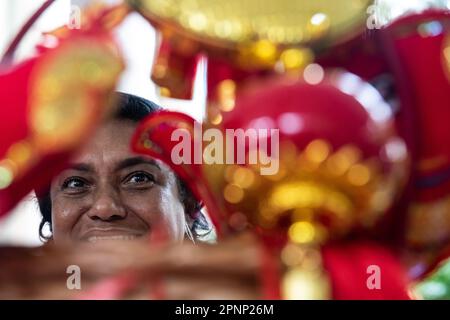 Rio De Janeiro, Brazil. 19th Apr, 2023. A woman looks at Chinese handicrafts during an event celebrating the upcoming UN Chinese Language Day in Rio de Janeiro, Brazil, on April 19, 2023. The UN Chinese Language Day is observed every year on or around April 20, when the contribution of Chinese literature, poetry, and language to world culture is highlighted. Credit: Wang Tiancong/Xinhua/Alamy Live News Stock Photo