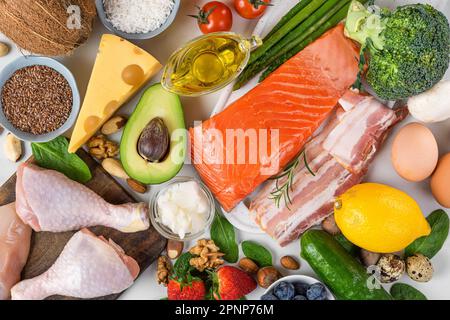 Balanced low carb keto diet food. Food sources of protein, healthy fats, carbs. Top view. Fish, meat, vegetables, fruits, nuts, eggs for ketogenic die Stock Photo