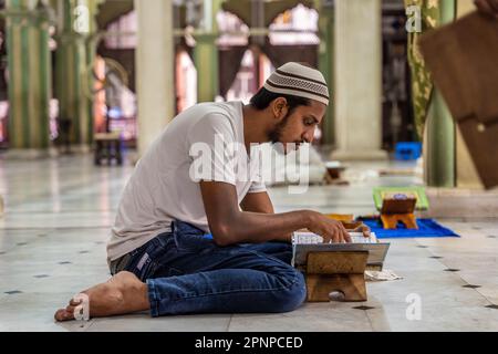 Kolkata, India. 19th Apr, 2023. An Indian Muslim boy wearing the traditional Muslim cap reads Quran inside of Nakhoda Mosque in Kolkata. Credit: SOPA Images Limited/Alamy Live News Stock Photo